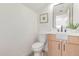 Bright powder room featuring a sleek vanity with modern fixtures, mirror, and decor at 6439 E Redmont Dr, Mesa, AZ 85215