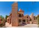 Unique home exterior with a beige stucco finish, red tile roof, and private courtyard at 6439 E Redmont Dr, Mesa, AZ 85215