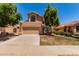 Charming home features a well-maintained lawn, mature shade trees, and a welcoming two-car garage at 6439 E Redmont Dr, Mesa, AZ 85215