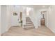 Inviting foyer with a staircase, bright white walls and light wood-look flooring at 6439 E Redmont Dr, Mesa, AZ 85215