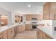Modern kitchen with wood cabinetry, quartz countertops, and stainless steel appliances at 6439 E Redmont Dr, Mesa, AZ 85215