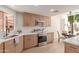 Bright kitchen features stainless steel appliances, white counters, and light wood cabinetry at 6439 E Redmont Dr, Mesa, AZ 85215