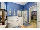 Ensuite bathroom featuring a soaking tub, glass enclosed shower, and tile floors at 776 W Carob Way, Chandler, AZ 85248