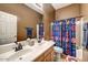 Bathroom featuring double sinks, superhero-themed shower curtain, and coordinated decor at 776 W Carob Way, Chandler, AZ 85248