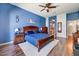Primary bedroom featuring a wood-framed bed, and views to ensuite bath and walk-in closet at 776 W Carob Way, Chandler, AZ 85248