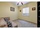 Bedroom with neutral carpet and walls, minimalist decor and a comfortable, cushioned couch at 776 W Carob Way, Chandler, AZ 85248