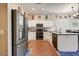 Modern kitchen featuring white cabinets, granite countertops, and stainless steel appliances at 776 W Carob Way, Chandler, AZ 85248