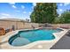 Backyard pool featuring lush landscaping, a brick privacy fence, and waterfall features at 776 W Carob Way, Chandler, AZ 85248