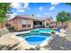 Backyard featuring a unique pool design, covered patio, and well-maintained landscaping at 776 W Carob Way, Chandler, AZ 85248