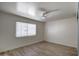 Bedroom featuring hard surface floors, a ceiling fan, and a window that provides natural light at 7920 E Camelback Rd # 609, Scottsdale, AZ 85251