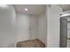 Bright entryway featuring a white door, wood-look floors, and stainless steel appliances visible from the kitchen at 7920 E Camelback Rd # 609, Scottsdale, AZ 85251