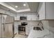 Bright kitchen with white cabinets, marble countertops, stainless steel appliances, and recessed lighting at 7920 E Camelback Rd # 609, Scottsdale, AZ 85251