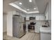 Modern kitchen featuring stainless steel appliances, marble countertops, white cabinetry and recessed lighting at 7920 E Camelback Rd # 609, Scottsdale, AZ 85251
