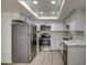Bright kitchen with white cabinets, quartz countertops, stainless steel appliances, and a sunlit skylight at 7920 E Camelback Rd # 609, Scottsdale, AZ 85251
