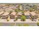 Suburban aerial view of neighborhood homes with solar panels, landscaping, and well-maintained streets at 8259 W Carol Ave, Peoria, AZ 85345