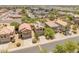 Suburban aerial view of a neighborhood featuring a two-story home with solar panels at 8259 W Carol Ave, Peoria, AZ 85345