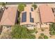Aerial view of a home featuring solar panels on the roof and a backyard with a patio and artificial turf at 8259 W Carol Ave, Peoria, AZ 85345