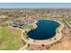 Aerial view of the beautiful Pioneer Community Park with its lake, playground, and green spaces at 8259 W Carol Ave, Peoria, AZ 85345