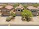 An aerial view of the home with solar panels surrounded by other residential properties at 8259 W Carol Ave, Peoria, AZ 85345