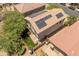 Backyard view of a home featuring solar panels, a patio with seating, and low-maintenance artificial turf at 8259 W Carol Ave, Peoria, AZ 85345