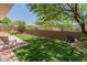 Backyard features desert landscaping with rock and artificial turf at 8259 W Carol Ave, Peoria, AZ 85345