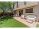 Cozy backyard patio with artificial turf and desert landscaping at 8259 W Carol Ave, Peoria, AZ 85345