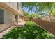 Well-manicured backyard with artificial turf and privacy wall at 8259 W Carol Ave, Peoria, AZ 85345