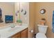 Charming half bathroom with decorative stars and moon artwork, and neutral colored walls at 8259 W Carol Ave, Peoria, AZ 85345