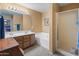 Bathroom featuring double sinks, a soaking tub, and a glass-enclosed shower at 8259 W Carol Ave, Peoria, AZ 85345