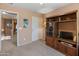 Upstairs bedroom featuring built-in shelving, neutral paint, and hallway view at 8259 W Carol Ave, Peoria, AZ 85345