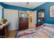 Bedroom featuring a blue accent wall, artwork and an ensuite bathroom at 8259 W Carol Ave, Peoria, AZ 85345