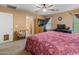 Spacious bedroom featuring a large bed, a ceiling fan, and an ensuite bathroom at 8259 W Carol Ave, Peoria, AZ 85345