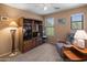 Cozy bedroom with large windows, a media center and a comfortable recliner at 8259 W Carol Ave, Peoria, AZ 85345