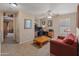 Comfortable bonus room featuring neutral walls, ceiling fan, and versatile seating and desk areas at 8259 W Carol Ave, Peoria, AZ 85345
