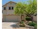 Two-story home featuring a two-car garage and a well-maintained front yard at 8259 W Carol Ave, Peoria, AZ 85345