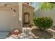 A cozy front entrance adorned with plants and a decorative exterior with shade tree at 8259 W Carol Ave, Peoria, AZ 85345