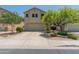 Inviting two-story home featuring a neutral-colored exterior, a spacious driveway, and attractive landscaping at 8259 W Carol Ave, Peoria, AZ 85345