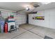 Spacious garage featuring extra storage cabinets and access to house at 8259 W Carol Ave, Peoria, AZ 85345