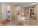 Upstairs hallway with laundry room access, plush carpet and neutral colored walls at 8259 W Carol Ave, Peoria, AZ 85345