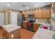 Beautiful kitchen with stainless steel appliances, wood cabinets and bright lighting at 8259 W Carol Ave, Peoria, AZ 85345