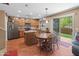 Bright kitchen area with an island and dining table, with oak cabinets and stainless appliances at 8259 W Carol Ave, Peoria, AZ 85345