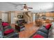 Spacious living area featuring wood floors, a ceiling fan, and an open floor plan at 8259 W Carol Ave, Peoria, AZ 85345