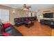 Relaxing living room with a TV and a dark leather couch, next to a dark wood coffee table at 8259 W Carol Ave, Peoria, AZ 85345