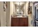 Bathroom vanity featuring a sink, mirror, and decorative accents at 8421 E Main St # 116, Mesa, AZ 85207