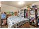 Comfortable bedroom featuring a floral quilt and built-in shelving at 8421 E Main St # 116, Mesa, AZ 85207