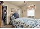 View of a bedroom featuring a comfortable floral quilt at 8421 E Main St # 116, Mesa, AZ 85207