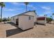 Mobile home with neutral exterior, storage sheds, desert landscaping and nearby palm trees at 8421 E Main St # 116, Mesa, AZ 85207