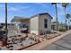 Inviting manufactured home featuring desert landscaping, covered parking, and a charming, well-maintained exterior at 8421 E Main St # 116, Mesa, AZ 85207