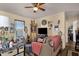 Cozy living room with a ceiling fan, TV, natural light from the window, and a comfortable seating area at 8421 E Main St # 116, Mesa, AZ 85207