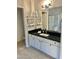 This bathroom has a black countertop, a white cabinet and a large mirror at 9212 W Salter Dr, Peoria, AZ 85382